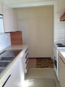A small galley kitchen replaced the original kitchen out the back. A new kitchen will be relocated in another room.
