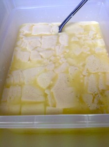 Turning the whey - after gently heating milk and mixing in rennet and bacteria or starter. Then letting it set a little and cutting it.