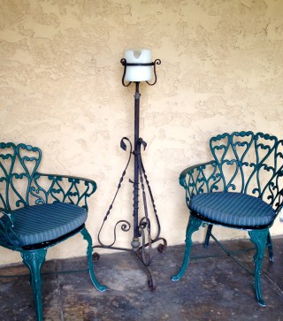 An unexpected bargain - an old iron kerosine stand makes a wonderful stand for a candle in the Cloisters.