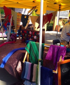 Scarves with lots of shawls in the background.